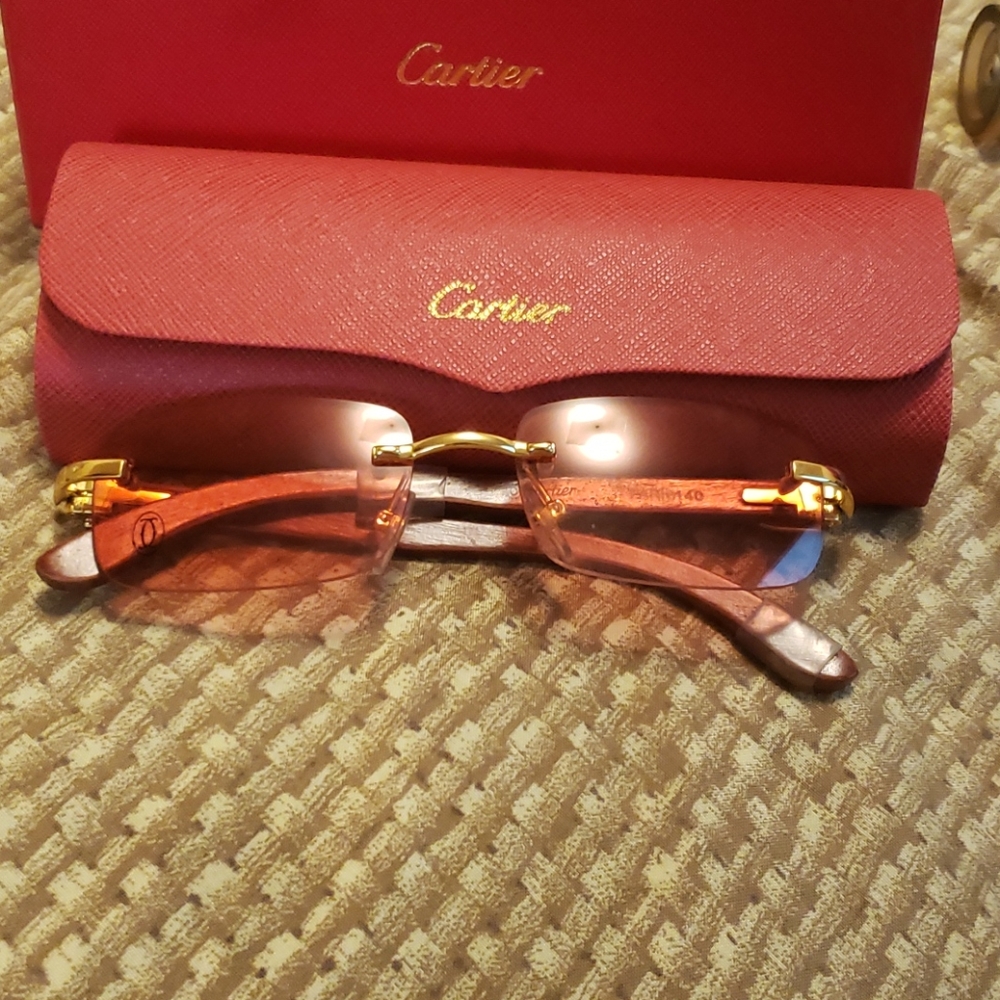 Rose colored Cartier  rimless buffs